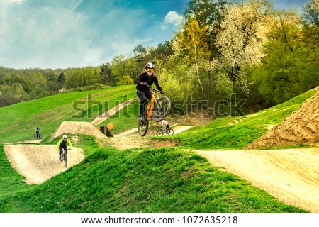Mountain biker jumping on bike in the bikepark. Extreme sport. 