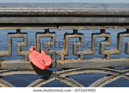 A padlock on a parapet as a symbol of loving hearts held together forever.