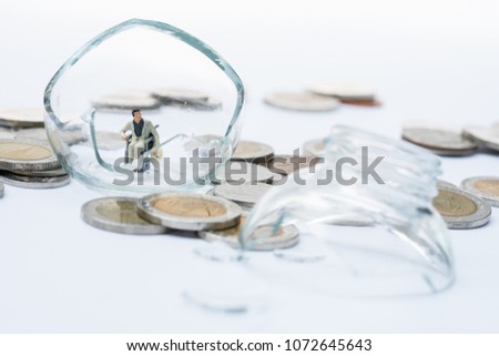 Miniature people, patient in wheelchair on coins stack with broken jar of coins as backdrop. Concept of money saving, financial, life insurance, retirement, investment, and health care.