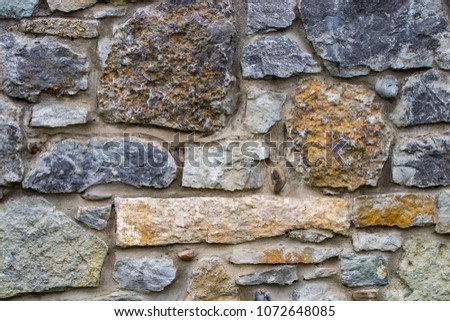 abstraction wall fence built of natural stone background.

