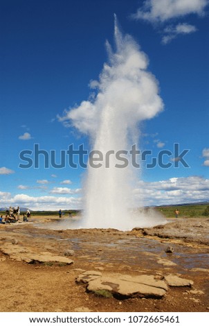 Iceland. Photographers take a geyser eruption