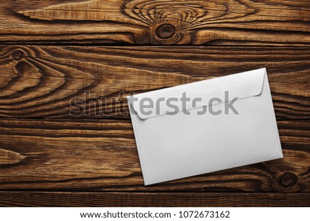Two white envelopes with letters on old wooden dark background. Blanks for the designer. Concepts, ideas for postal services and e-mail.
