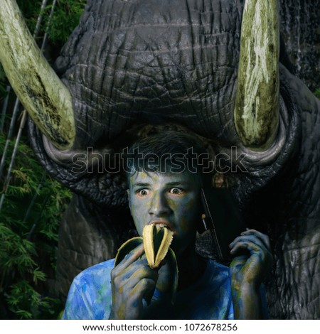 huge animal with large tusks, is about to attack a jaunted tourist in the jungle, the concept