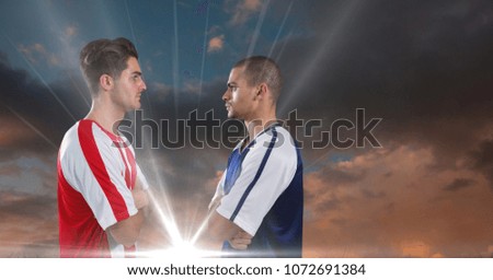 Digital composite of very serious soccer players looking each other. cloudy day, light
