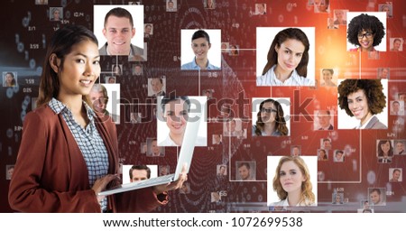 Digital composite of Smiling businesswoman holding laptop against portraits