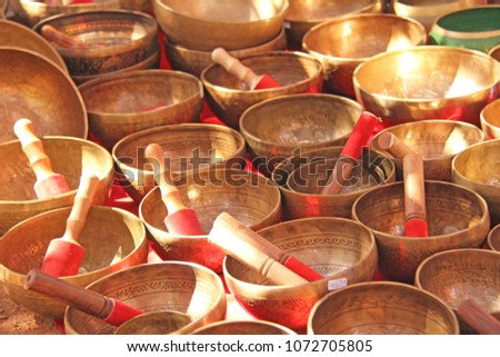 Singing bowls of bronze. Golden singing bowls are sold on the market in India. Tibetan singing thickets.