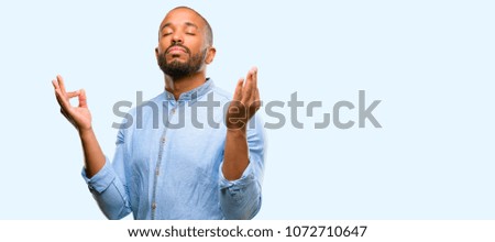 African american man with beard doing ok sign gesture with both hands expressing meditation and relaxation isolated over blue background