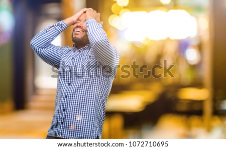 African american man with beard stressful keeping hands on head, tired and frustrated at night
