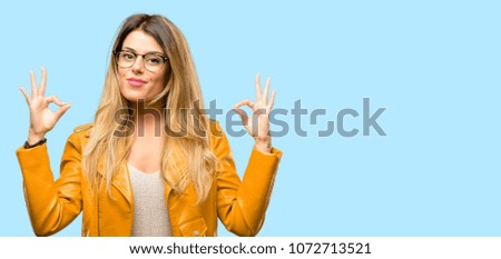 Beautiful young woman doing ok sign gesture with both hands expressing meditation and relaxation
