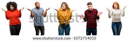 Group of cool people, woman and man doubt expression, confuse and wonder concept, uncertain future shrugging shoulders Royalty-Free Stock Photo #1072714010