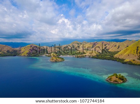 Beautiful aerial view of beaches and tourist boat sailing in Flores Island, Indonesia