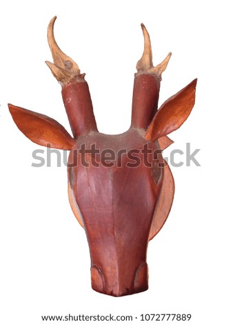 Wood carving, the head of the muntiacus, isolated on white background with clipping path.