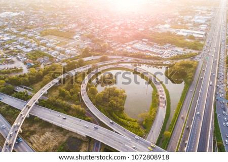 Aerial view transport junction road car movement with pond and tree sunset light, Vehicle on road