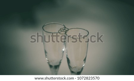wedding decorations theme, flowers and champagne in white interior. bottle of champagne and glasses - vintage film look