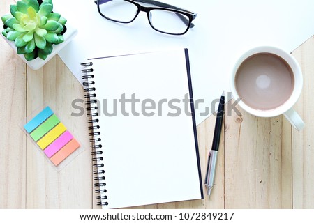 Still life, planning or education concept : Top view or flat lay of open notebook with blank pages and coffee cup on office table with copy space ready for adding or mock up