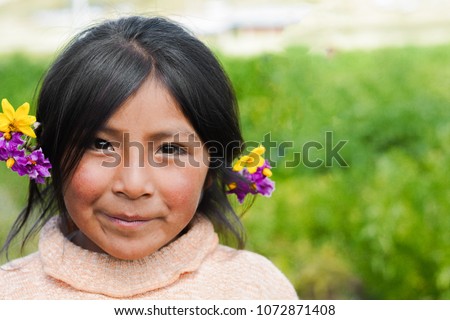 Beautiful native american little girl with flowers in her hair. Royalty-Free Stock Photo #1072871408
