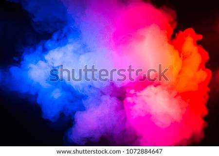 Texture of multi-colored smoke on a black background