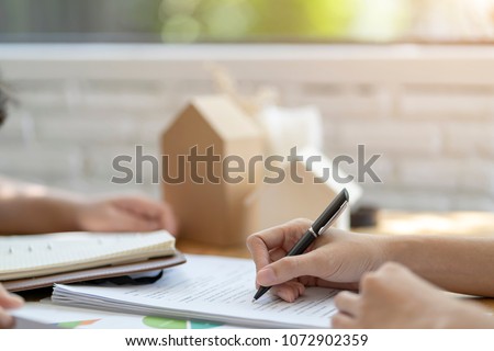 Woman putting signature on document  loan contract, real estate purchase, success business contract deals with sale represent.