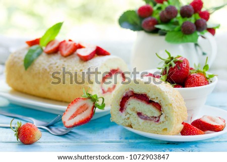Homemade swiss roll biscuit cake with fresh strawberries
