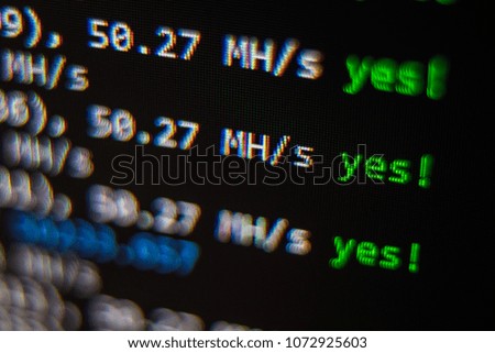 Close-up image of the computer s screen showing the blur of the programing code and a word BITCOIN for the concept of