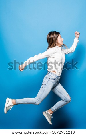 Successful young attractive laughing woman jumping up