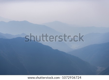 Mountain full of fog.Sunrise.vintage tone. Royalty-Free Stock Photo #1072936724
