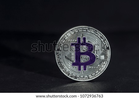 Close-up bitcoin silver coin with blurred background. Digital currency