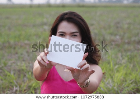 Woman showing empty paper