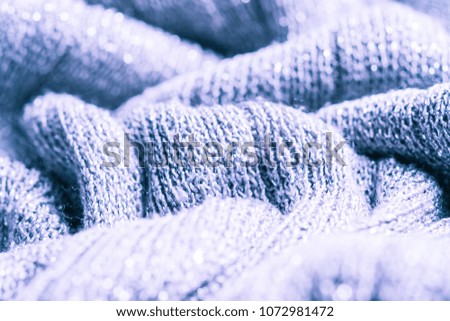 Beautiful abstract art background of detail bright colorful knitted pattern texture. Polyester synthetic or natural warm plaid. Comfortable home textile. Closeup palette texture
