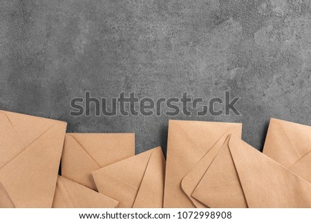 Brown envelopes on grey background, top view. Mail service