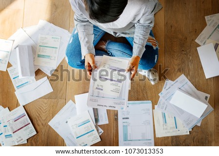 Woman managing the debt Royalty-Free Stock Photo #1073013353