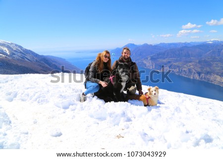 Couple with dog on the top hill of Monte Baldo over Garda lake