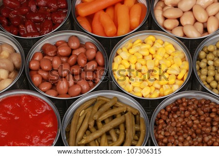 Different kinds of vegetables such as corn, peas and tomatoes in cans Royalty-Free Stock Photo #107306315