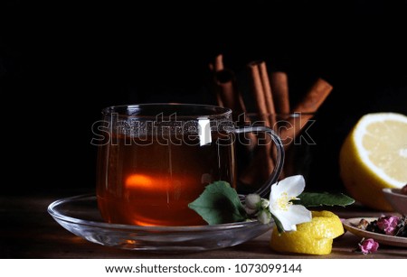 tea drink in a cup next to lies mint and spices