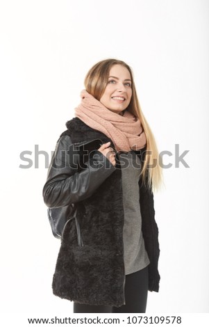 A girl in demi-season clothes with a bag on a white background