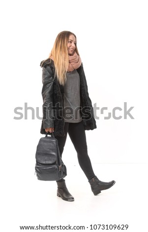 A girl in demi-season clothes with a full-length bag on a white background