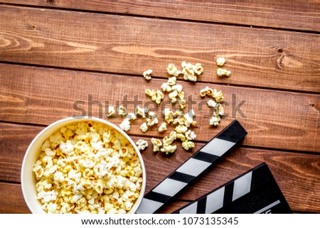 watching movie with popcorn on wooden background top view