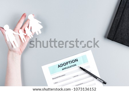 adoption form and family figures on desk background top view 
