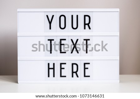 vintage lightbox with words "your text here" on the table