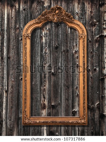 Classic mirror frame on a grungy wooden wall