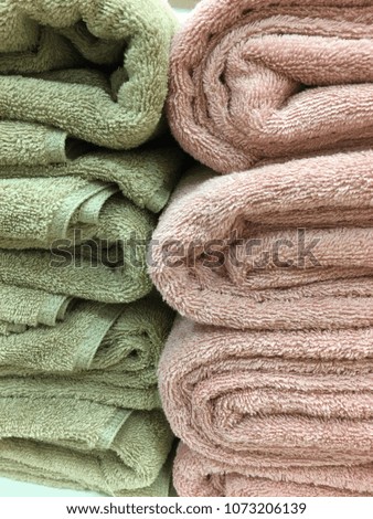 Towel rolls stack for use in hotels or in homes.