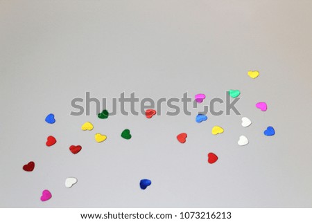 colorful confetti heart shape on a white piece of paper festive abstract background
