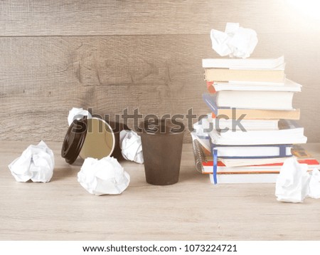 stack of books, crumpled paper, student preparing for exams, Cup of coffee