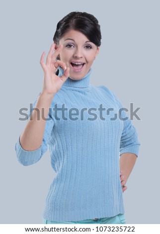 Portrait of  a beautiful woman showing the OK sign over white
