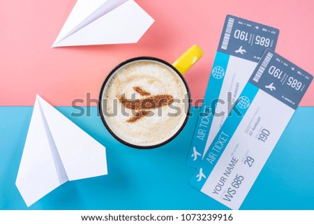 Coffee cappuccino with a picture of the airplane on the foam, top view. Pastel bright background. The concept of air travel.