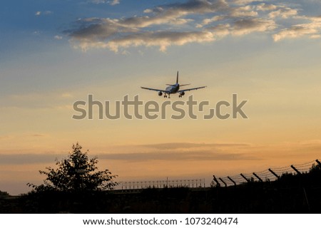 Plane landing at the sunset