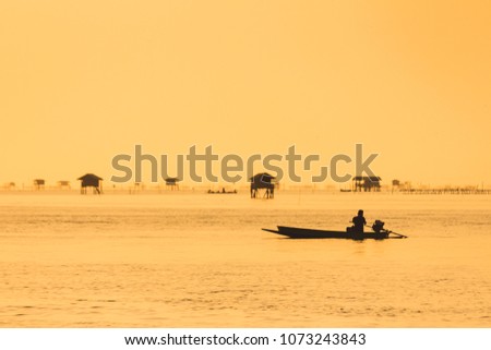 Silhouette photo of boat on the sea during Sunset in evening time.