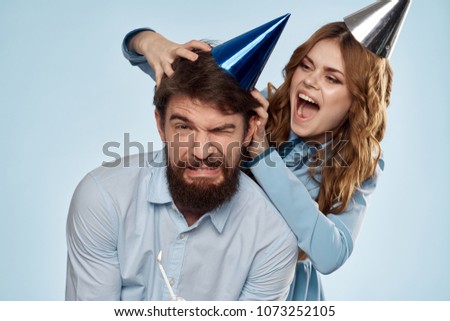 woman removes the cap from the head of a man                              