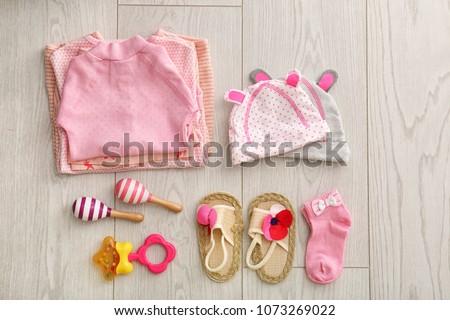 Flat lay composition with fashionable children's clothes on wooden background