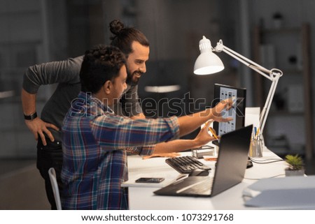 deadline, technology and people concept - creative team with computers working together late at night office Royalty-Free Stock Photo #1073291768